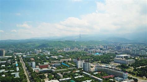 Premium Photo | View of almaty city with white clouds and blue sky