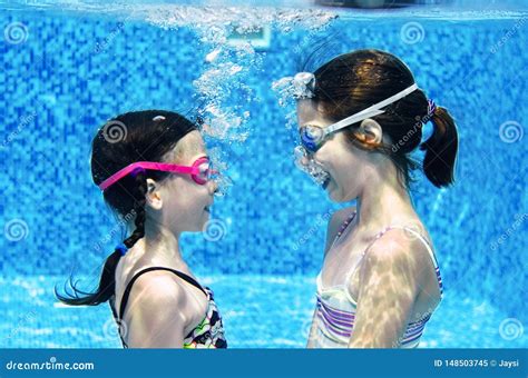 Children Swim in Swimming Pool Underwater, Happy Active Girls Have Fun ...