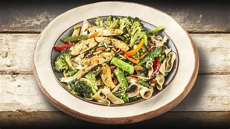 Premium AI Image | Noodles cooked in a wok with chicken and veggies