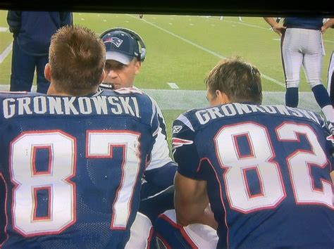 Gronkowski brothers sitting next to each other on the sideline : nfl