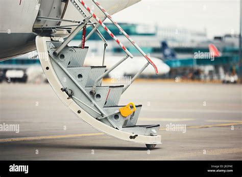 Airplane with open door is ready for boarding passengers at the busy ...