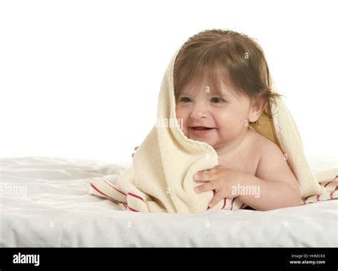 Baby girl lying under blanket Stock Photo - Alamy