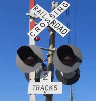 You arrive at a railroad crossing. The crossing has flashing red lights ...