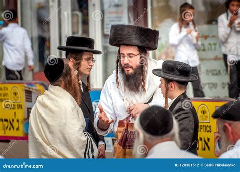 A Group of Hasidim Pilgrims in Traditional Clothing Emotionally Talk. Rosh Hashanah Holiday ...