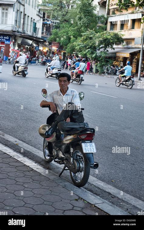 Motorcycle taxi driver at rest, Hanoi, Vietnam Stock Photo - Alamy