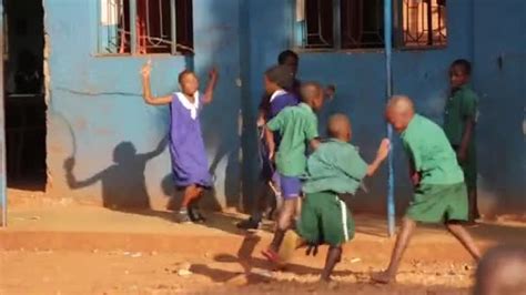 Young happy African children playing skipping at school in rural Masindi, Uganda, September 2013 ...