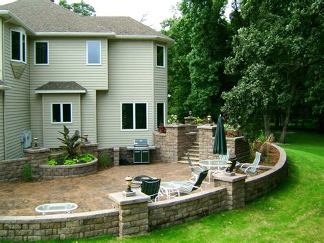 Stained Concrete Patio with Retaining Walls and Lots of Landscape Lighting | Oasis Landscapes ...