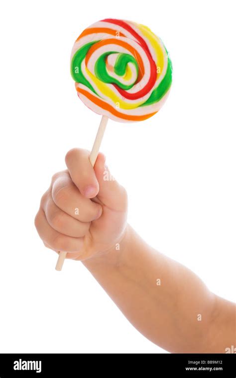 Color lollipop in child hand isolated on white Stock Photo - Alamy