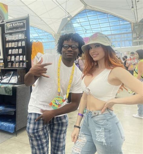 two people standing next to each other in front of a vending kiosk