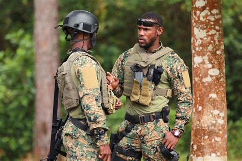 Jamaican soldiers assigned to the Jamaican defense force counterterrorism unit discuss tactics ...