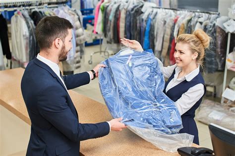 Girl worker Laundry man gives the client clean clothes at the dry ...