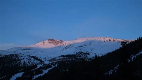 Sunset timelapse over snow peak and tree... | Stock Video | Pond5