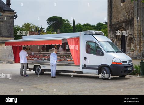 Mobile Butcher van visiting french village square Stock Photo - Alamy