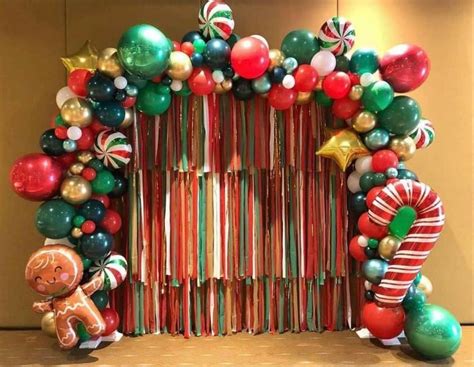 an arch made out of candy canes, balloons and candies with a ...