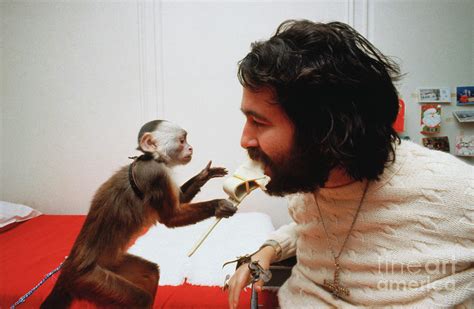 Monkey Feeding Paralyzed Man by Bettmann