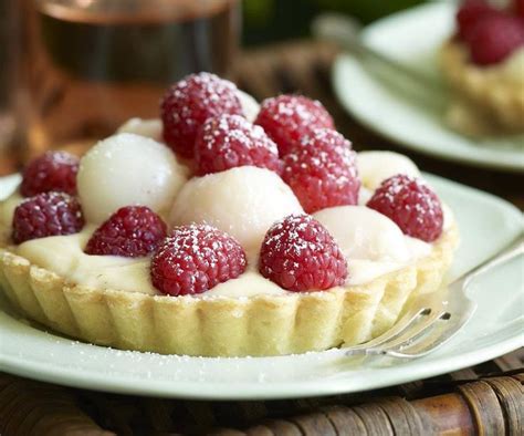 a dessert topped with raspberries and whipped cream