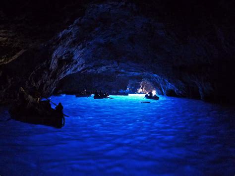 Float through the Blue Grotto, a sea cave in Capri with stunning blue light reflected off of the ...