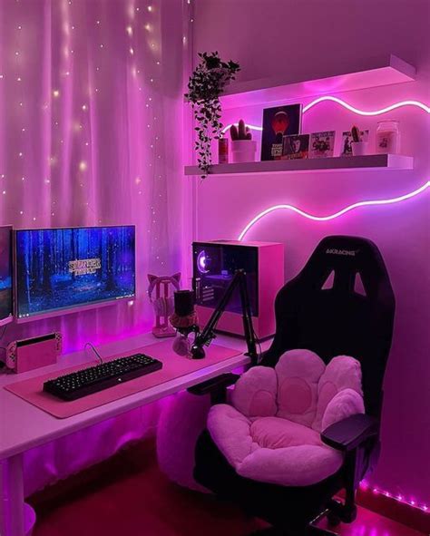 a computer desk with a chair, monitor and keyboard in front of the screen is lit up by purple lights