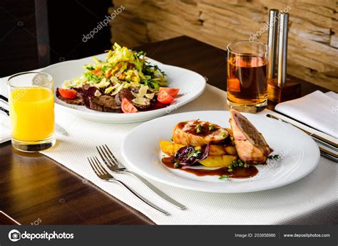 Romantic dinner at a restaurant. Appetizing dishes with meat and — Stock Photo © smspsy #203858986