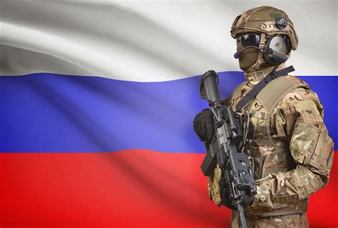 Soldier in helmet holding machine gun with flag on background series - Russia - Young Diplomats