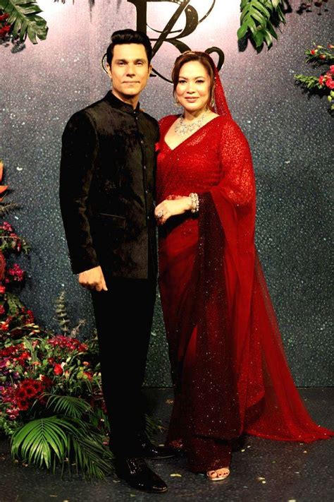 Actor Randeep Hooda, along with his wife Lin Laishram, poses for photos ...