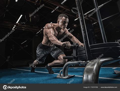 Fitness sled push man pushing weights workout exercise — Stock Photo © roman.l.olegovic #170274788