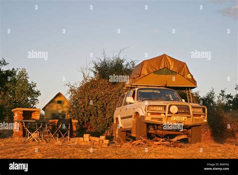 Toyota Land Cruiser 4x4 with tent loaded onto its roof at a campsite in Ihaha, Chobe National ...