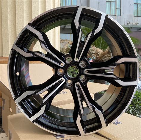 a black and silver wheel is sitting on a cardboard box in front of a building