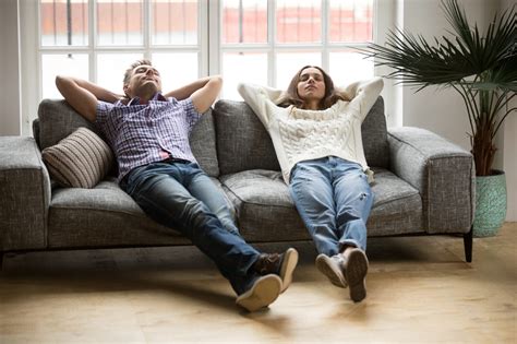 Young couple relaxing together on sofa enjoying nap breathing air - Panacea.mk