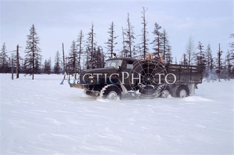 An Ural truck carrying supplies through deep snow on a winter road in ...