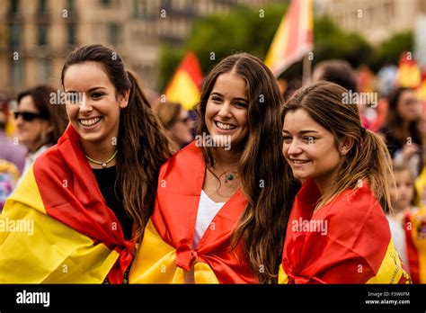 Barcelona, Spain. 12th Oct, 2015. Catalan girls have Spanish flags painted on her face as they ...