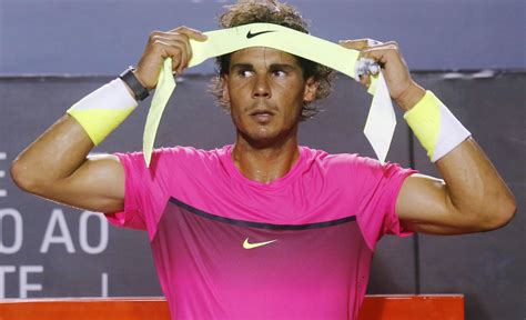 Rafael Nadal of Spain puts on his headband, during a break of his men’s singles tennis semi ...