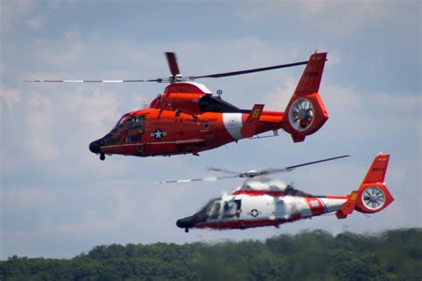 USCG helicopters demonstrate rescue maneuvers at the Cherry Festival airshow in Traverse City ...