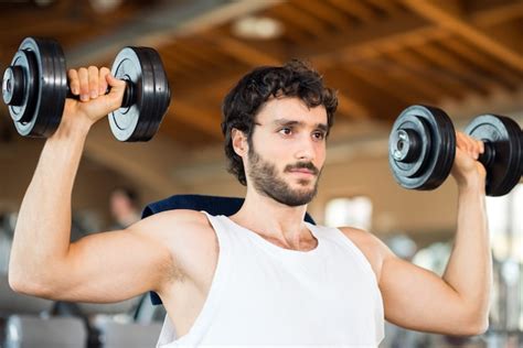 Premium Photo | Man lifting weights in a gym