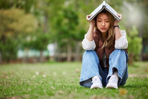 Premium Photo | Study sad and book with woman in park for studying ...