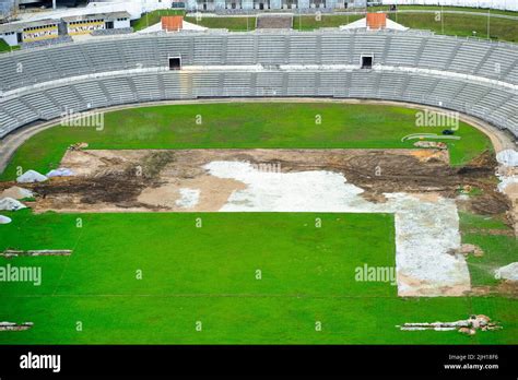 An aerial shot of large empty stadium with empty seats and destroyed ground Stock Photo - Alamy