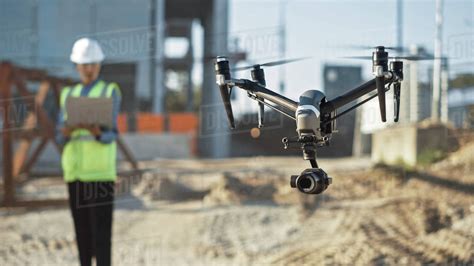 Specialist Controlling Drone on Construction Site. Architectural ...