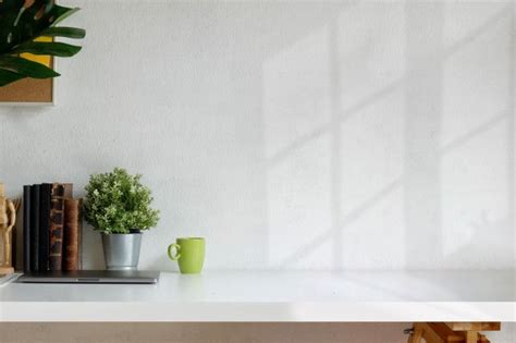 Loft Workspace with White Table, Books, and Plants