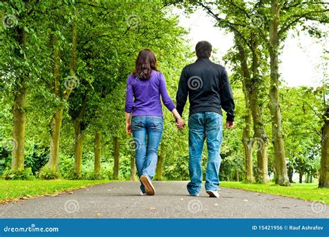 Couple Holding Hands And Walking In A Park Royalty Free Stock Image - Image: 15421956