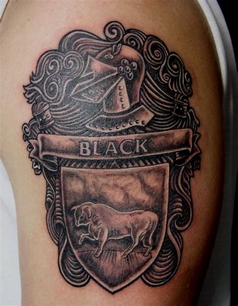 Black family crest with bull tattoo on half sleeve - Tattooimages.biz