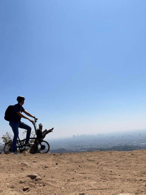 Premium Photo | Man sight seeing los angeles while riding electric ...