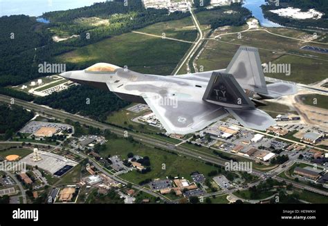 TYNDALL AIR FORCE BASE, Fla. -- The first operational F/A-22 Raptor flies over the base on its ...