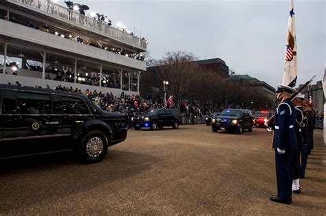 LAMINATED POSTER The U.S. presidential motorcade passes in front of the White House reviewing ...