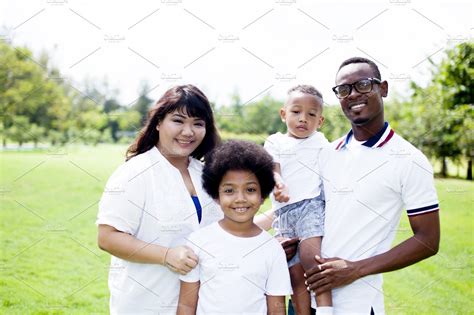 Happy diverse and mixed race family group photo in the park | High-Quality People Images ...