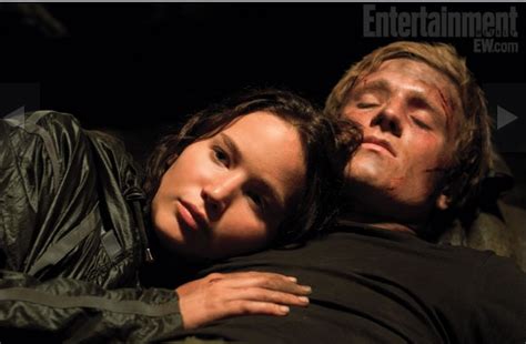 Image - Katniss with Peeta in cave.PNG - The Hunger Games Wiki