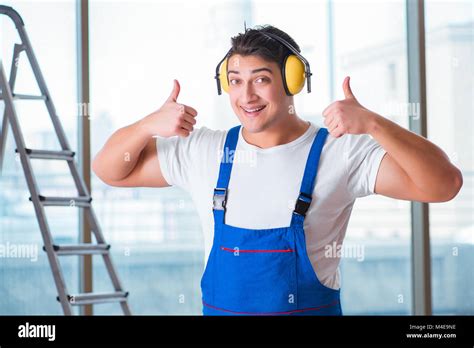 Worker with noise cancelling headphones Stock Photo - Alamy