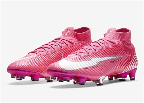 a pair of pink and white soccer cleats