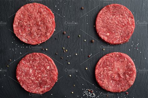 Fresh raw beef burger patties ~ Food & Drink Photos ~ Creative Market