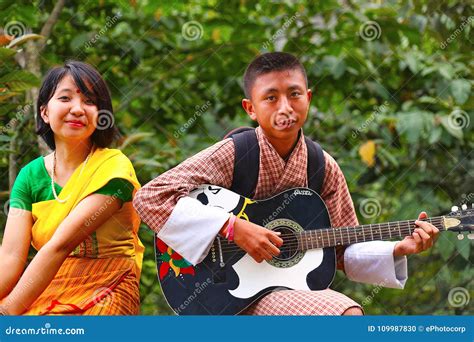 Bhutanese Boy And Girl Both In Traditional Clothes Stand Beside The Stairs , Bhutan Editorial ...