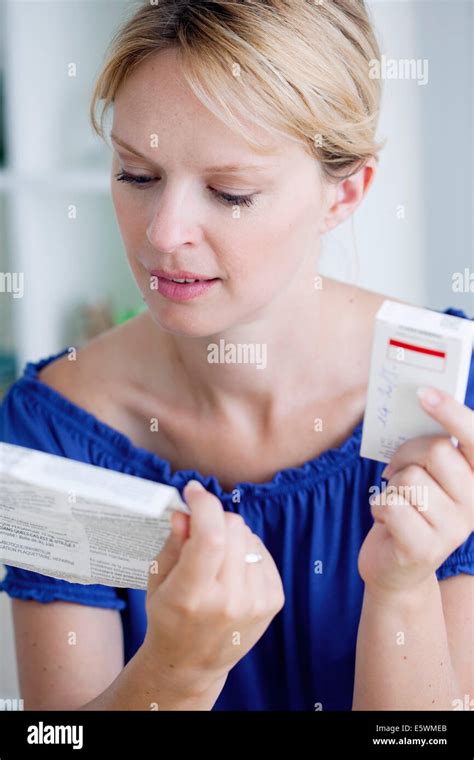 Woman taking medication Stock Photo - Alamy